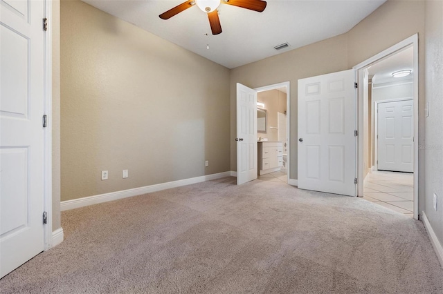 4323 Bayside Village Dr Unit 105, Tampa, FL 33615 - unfurnished bedroom featuring carpet floors, baseboards, connected bathroom, and a ceiling fan