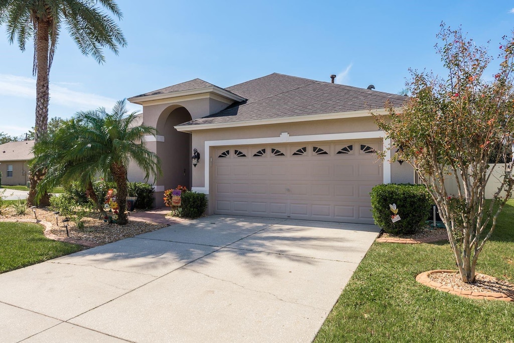 view of front of house with a front lawn and a garage