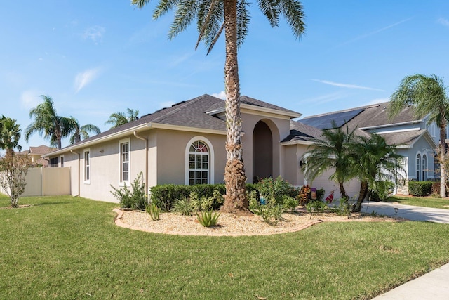 ranch-style house with a front yard and a garage