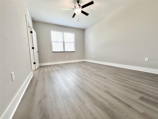 empty room with light hardwood / wood-style floors and ceiling fan