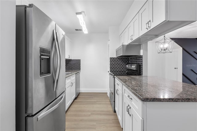 kitchen with backsplash, appliances with stainless steel finishes, light hardwood / wood-style flooring, and white cabinetry