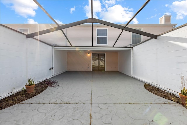 back of house featuring a carport