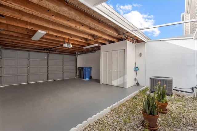 garage featuring central AC and a garage door opener