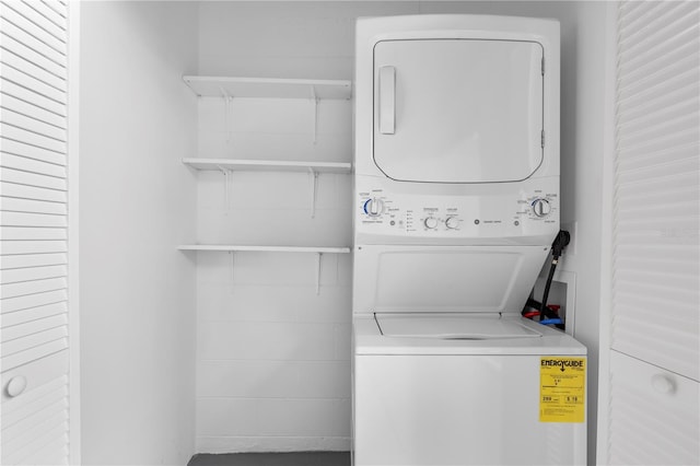 laundry area with stacked washing maching and dryer