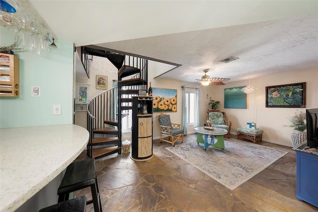 dining room with a textured ceiling and ceiling fan