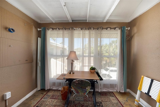 dining area featuring beam ceiling