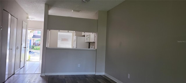 6212 Bayside Key Dr, Tampa, FL 33615 - foyer featuring wood finished floors, baseboards, and a textured ceiling