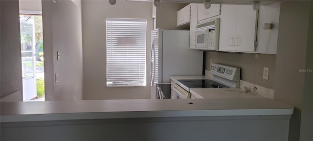 6212 Bayside Key Dr, Tampa, FL 33615 - kitchen featuring white appliances, light countertops, and white cabinetry