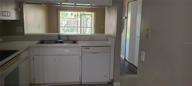 6212 Bayside Key Dr, Tampa, FL 33615 - kitchen with white dishwasher, a sink, stove, light countertops, and tile patterned floors