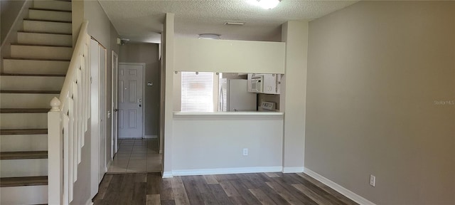 6212 Bayside Key Dr, Tampa, FL 33615 - staircase featuring wood finished floors, a textured ceiling, and baseboards