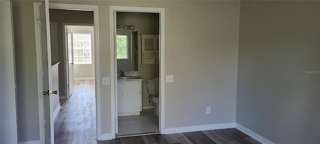 6212 Bayside Key Dr, Tampa, FL 33615 - unfurnished bedroom with dark wood-type flooring, baseboards, and a sink