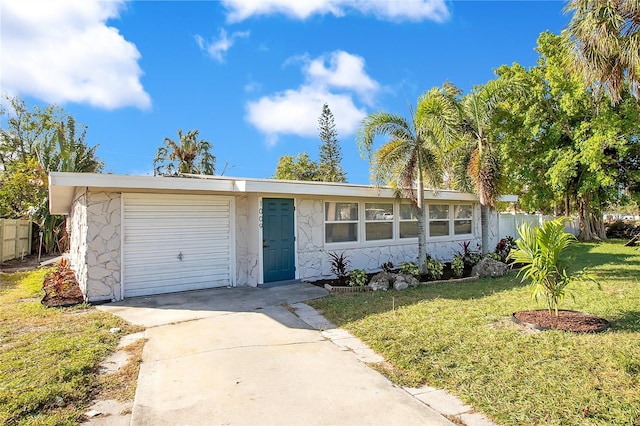 ranch-style house with a garage and a front lawn