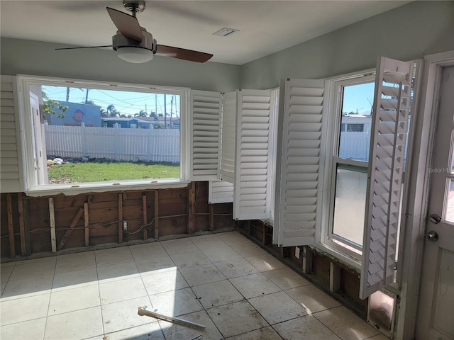 bathroom with ceiling fan and tile patterned floors