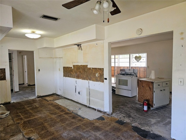 kitchen featuring ceiling fan and white stove