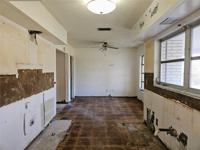 interior space with ceiling fan