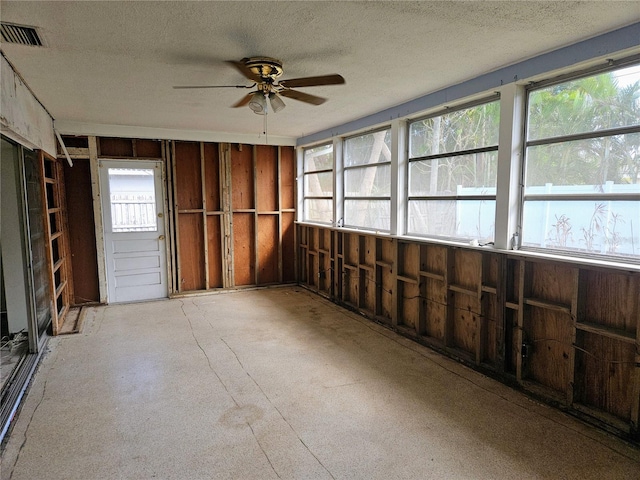 unfurnished sunroom featuring plenty of natural light and ceiling fan