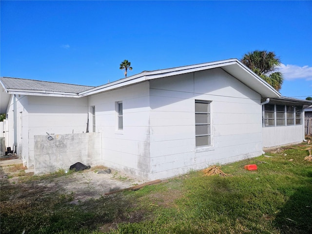 view of home's exterior with a yard