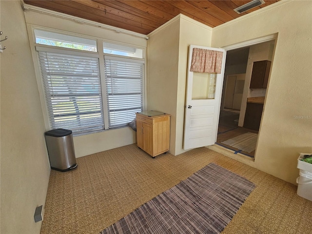 unfurnished bedroom featuring crown molding, multiple windows, and wooden ceiling