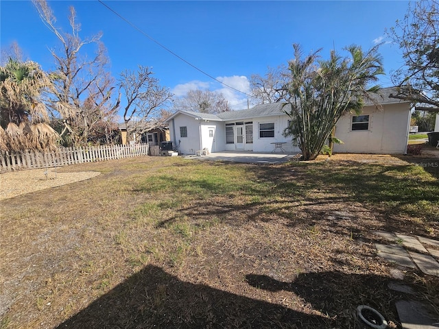 rear view of house with a patio area and a lawn