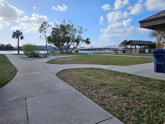 view of community with a gazebo, a yard, and a water view