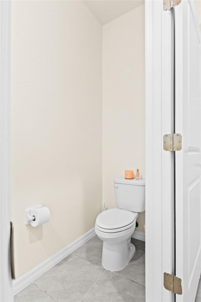 bathroom featuring toilet and tile patterned flooring