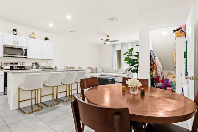 tiled dining area featuring ceiling fan