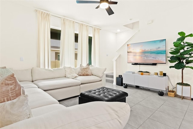 living room featuring light tile patterned flooring and ceiling fan