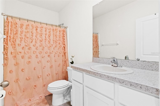 bathroom with vanity, toilet, tile patterned floors, and curtained shower