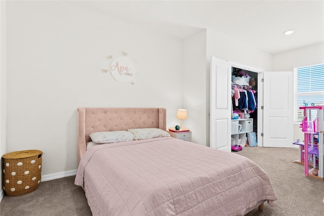 bedroom with a closet and light colored carpet