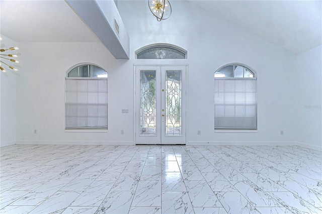 foyer entrance featuring marble finish floor, visible vents, a chandelier, and french doors