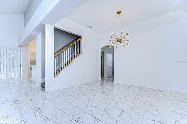 spare room featuring visible vents, baseboards, stairs, marble finish floor, and an inviting chandelier