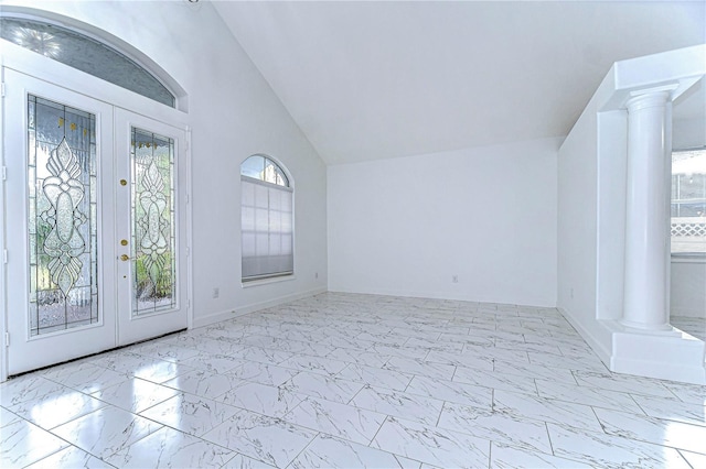 interior space featuring marble finish floor, french doors, and decorative columns