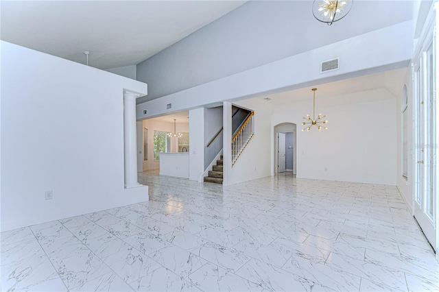 spare room with marble finish floor, stairs, visible vents, and a chandelier