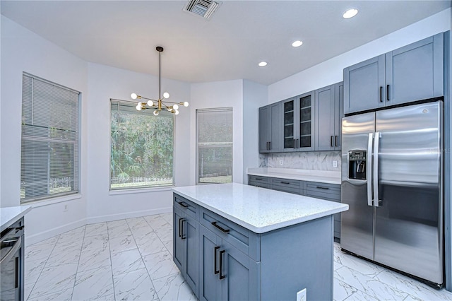 kitchen with hanging light fixtures, marble finish floor, glass insert cabinets, and stainless steel fridge with ice dispenser