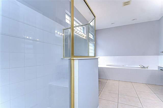 full bath with tile patterned flooring, visible vents, a tile shower, and a bath