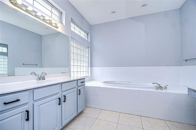 bathroom with tile patterned floors, vanity, and a bath