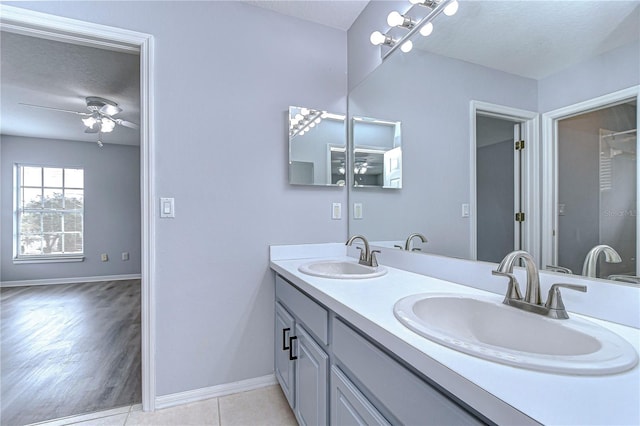 bathroom with a sink, a textured ceiling, and double vanity