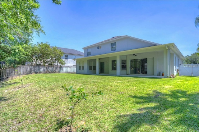 back of house featuring a yard, a patio area, a fenced backyard, and ceiling fan