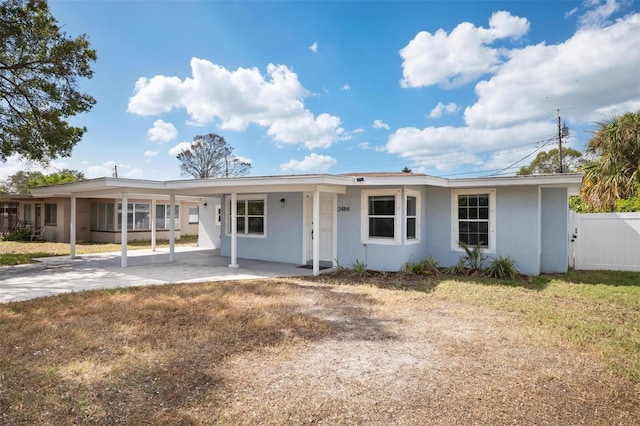 ranch-style home with a patio and a front lawn