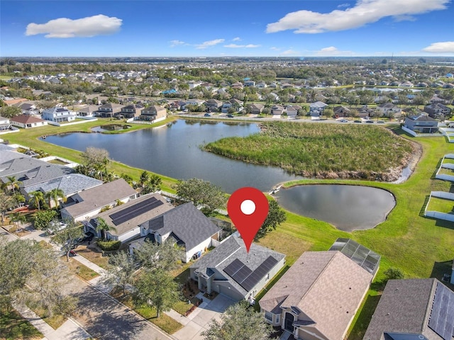 drone / aerial view featuring a residential view and a water view