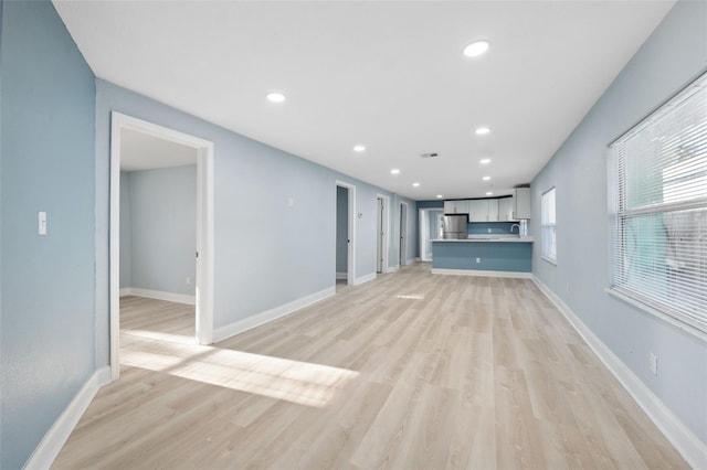 unfurnished living room featuring light hardwood / wood-style flooring