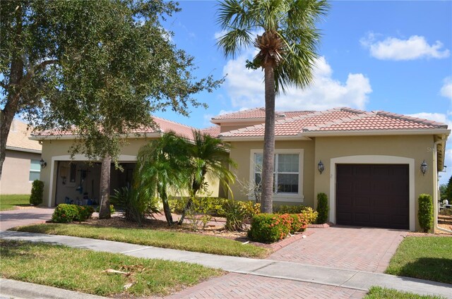 mediterranean / spanish-style house featuring a garage