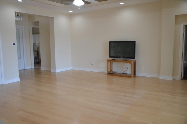 unfurnished living room with ceiling fan and light hardwood / wood-style flooring