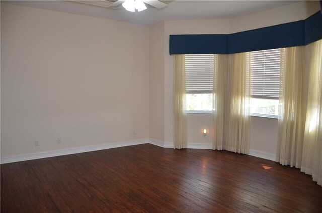 unfurnished room with dark hardwood / wood-style flooring and ceiling fan