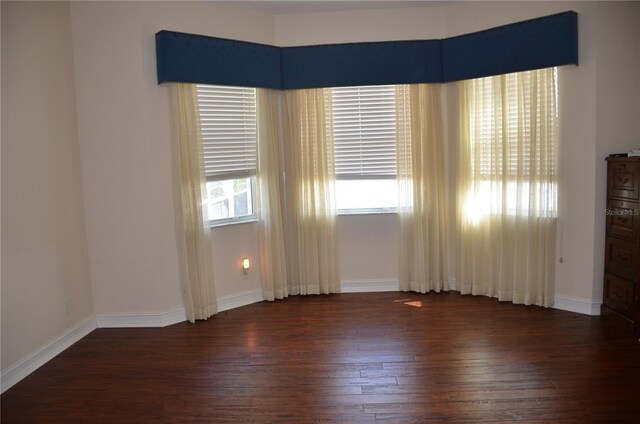 empty room with dark hardwood / wood-style floors