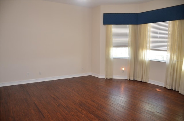 empty room featuring dark hardwood / wood-style flooring