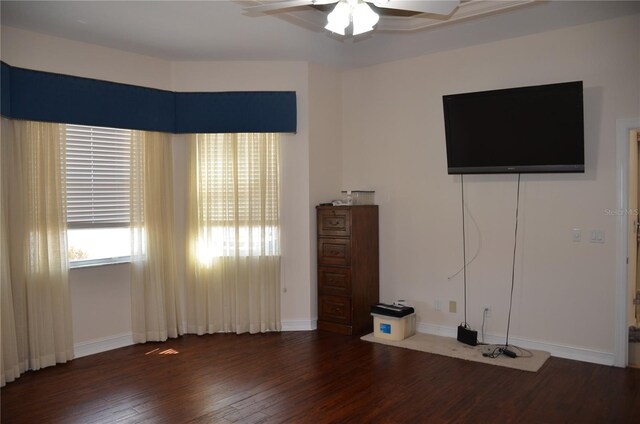 unfurnished bedroom with ceiling fan and dark hardwood / wood-style floors