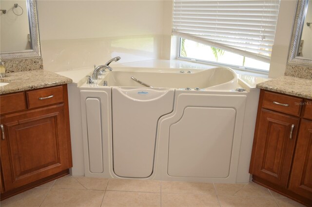 laundry area with light tile patterned floors