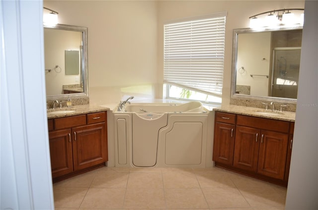 bathroom with vanity, a tub, and tile patterned flooring