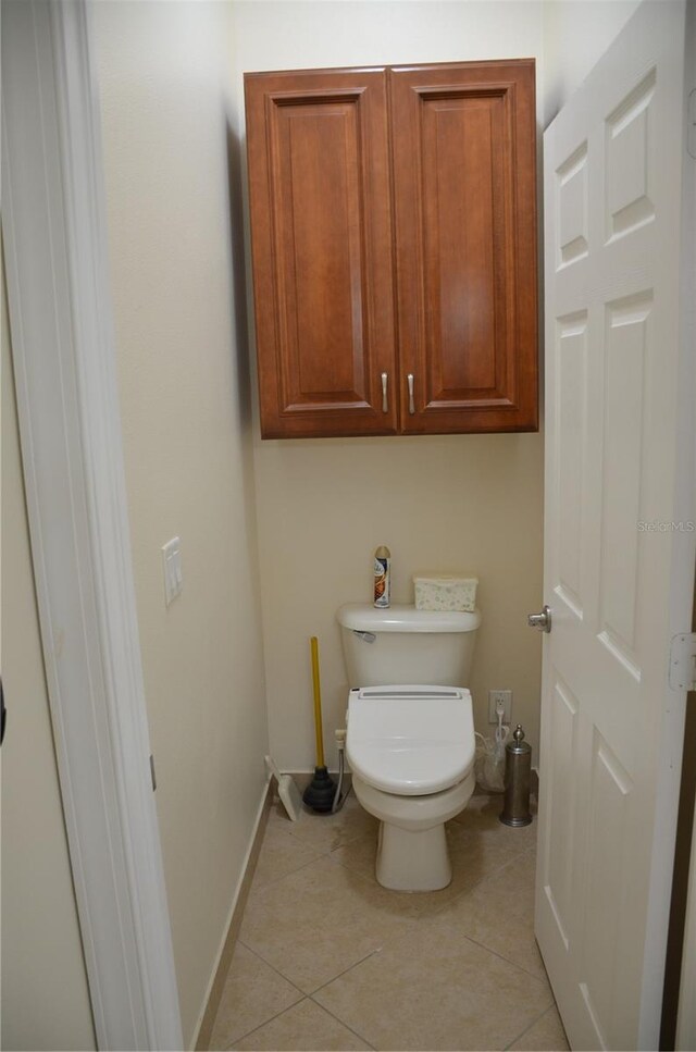 bathroom with toilet and tile patterned floors